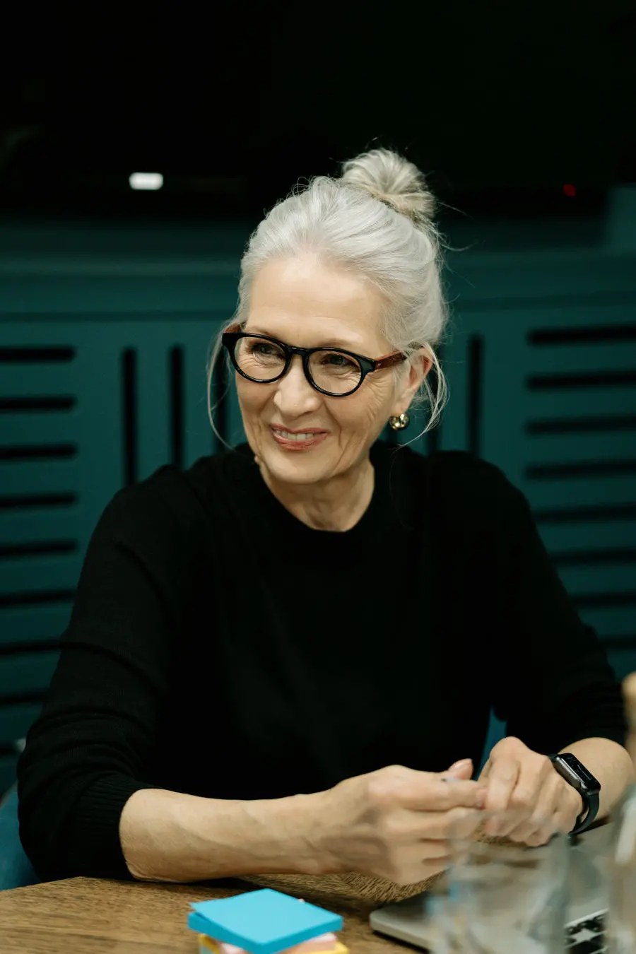 Smiling woman against a dark background