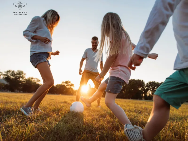 Family playing soccer